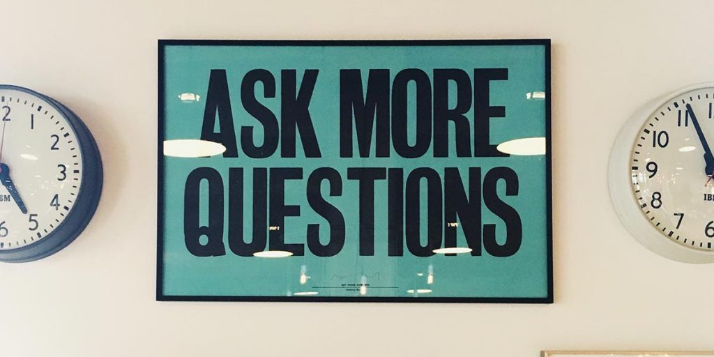 Plaque saying "Ask More Questions"