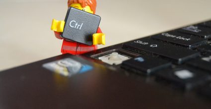 A lego figure removing the CTRL key from a computer keyboard